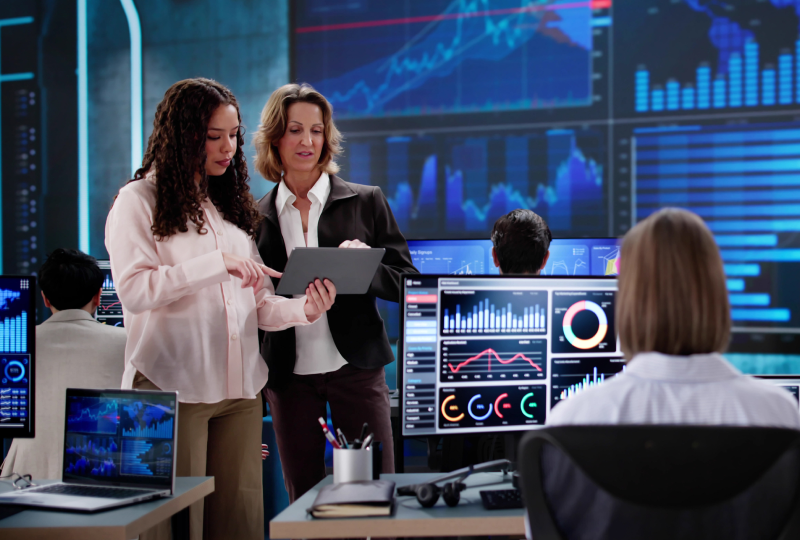 People discussing data in a control room.